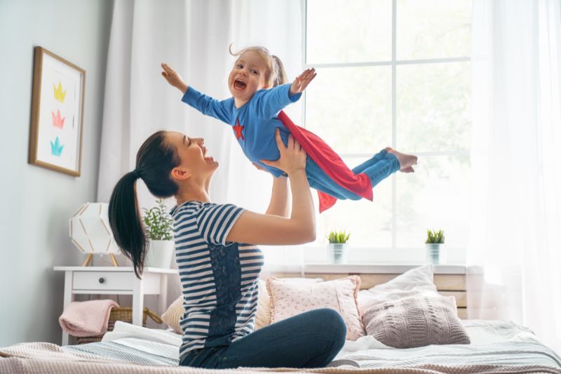 Single mom and child playing together, representing the joy of maximizing tax savings with helpful tips for single parents this tax season.